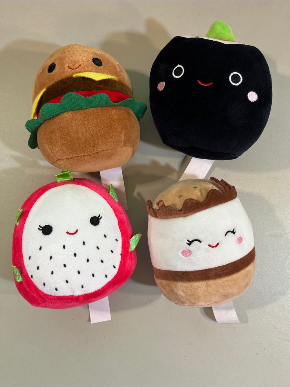 Squishmallows Plush Food Rattle Set - Brown, Black, Red, White